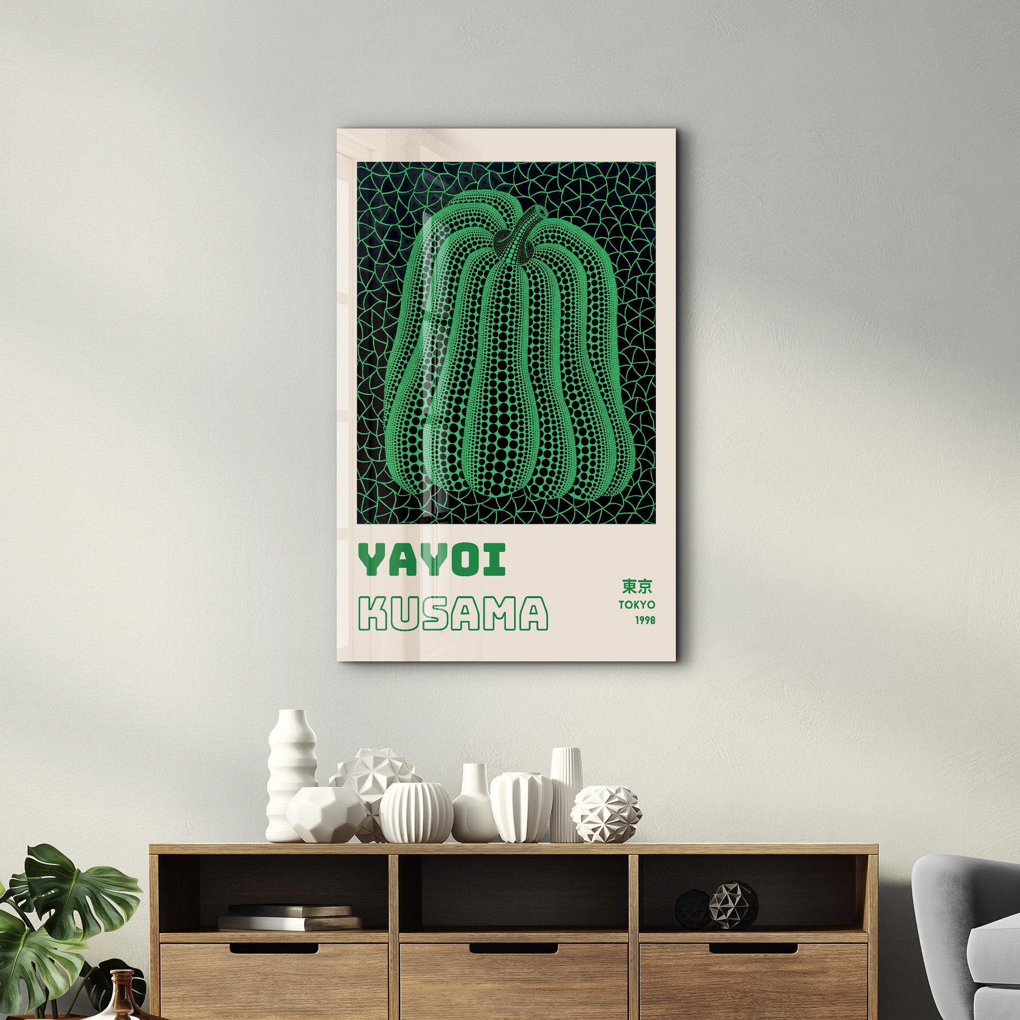 Glass wall art featuring Yayoi Kusama's green pumpkin design, a vibrant Japanese pop art piece by Artdesigna.